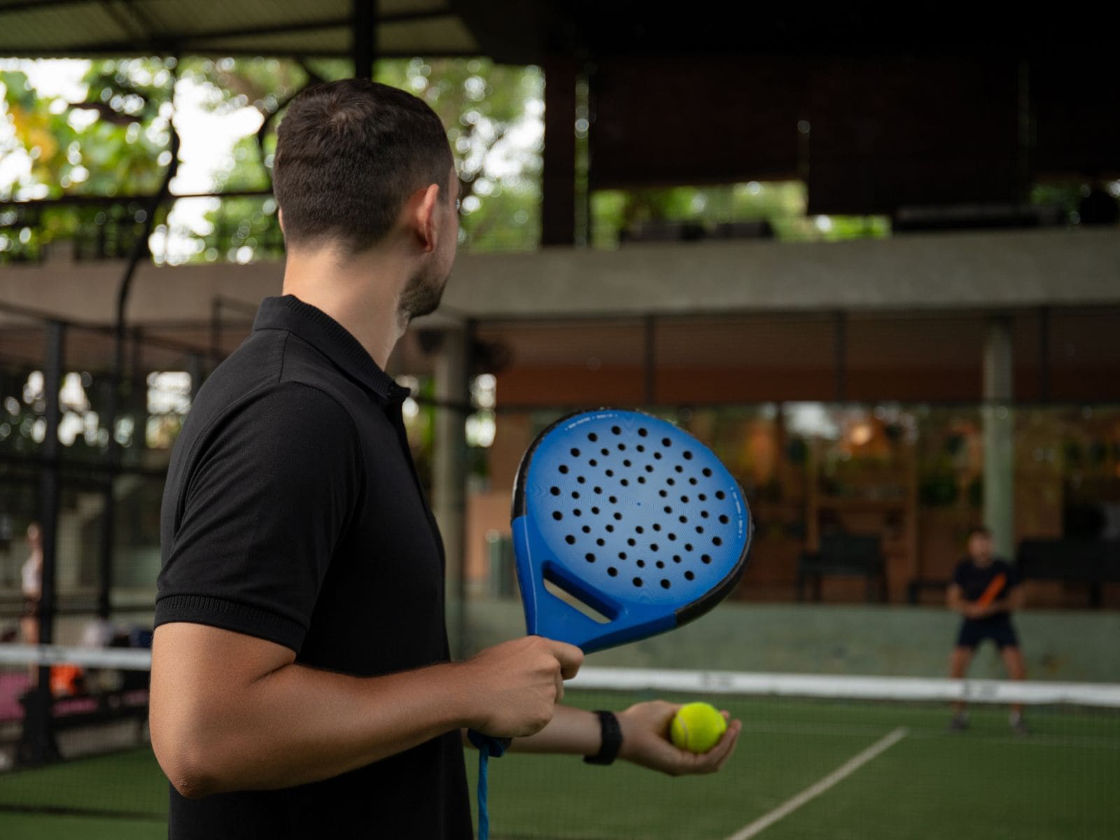 Beginner padel players learning on court