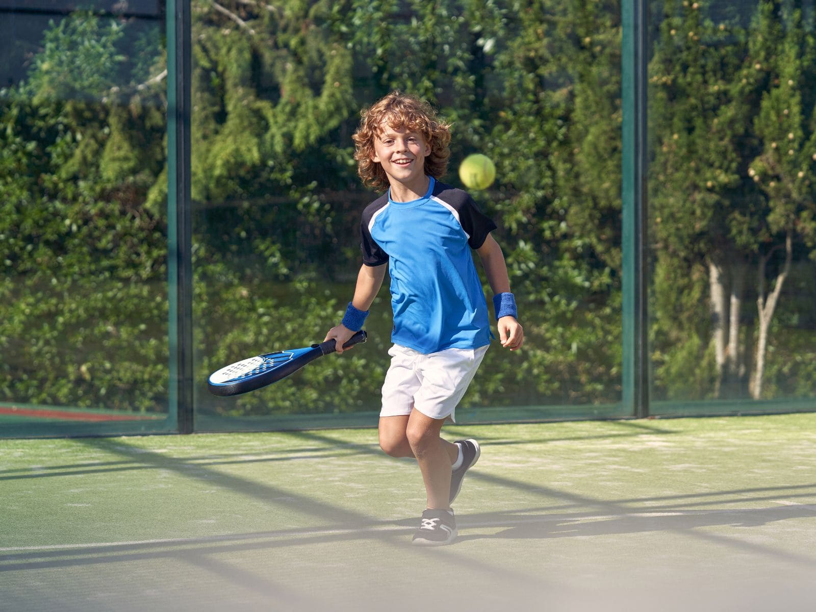 Children learning padel on court