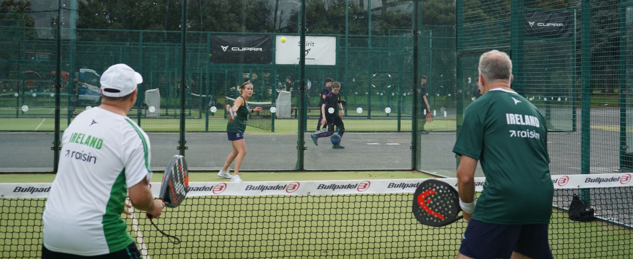 Adults playing padel together