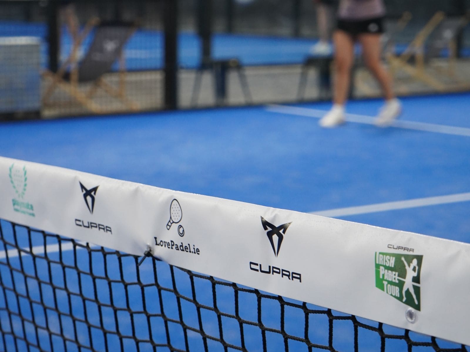 Padel players competing on court