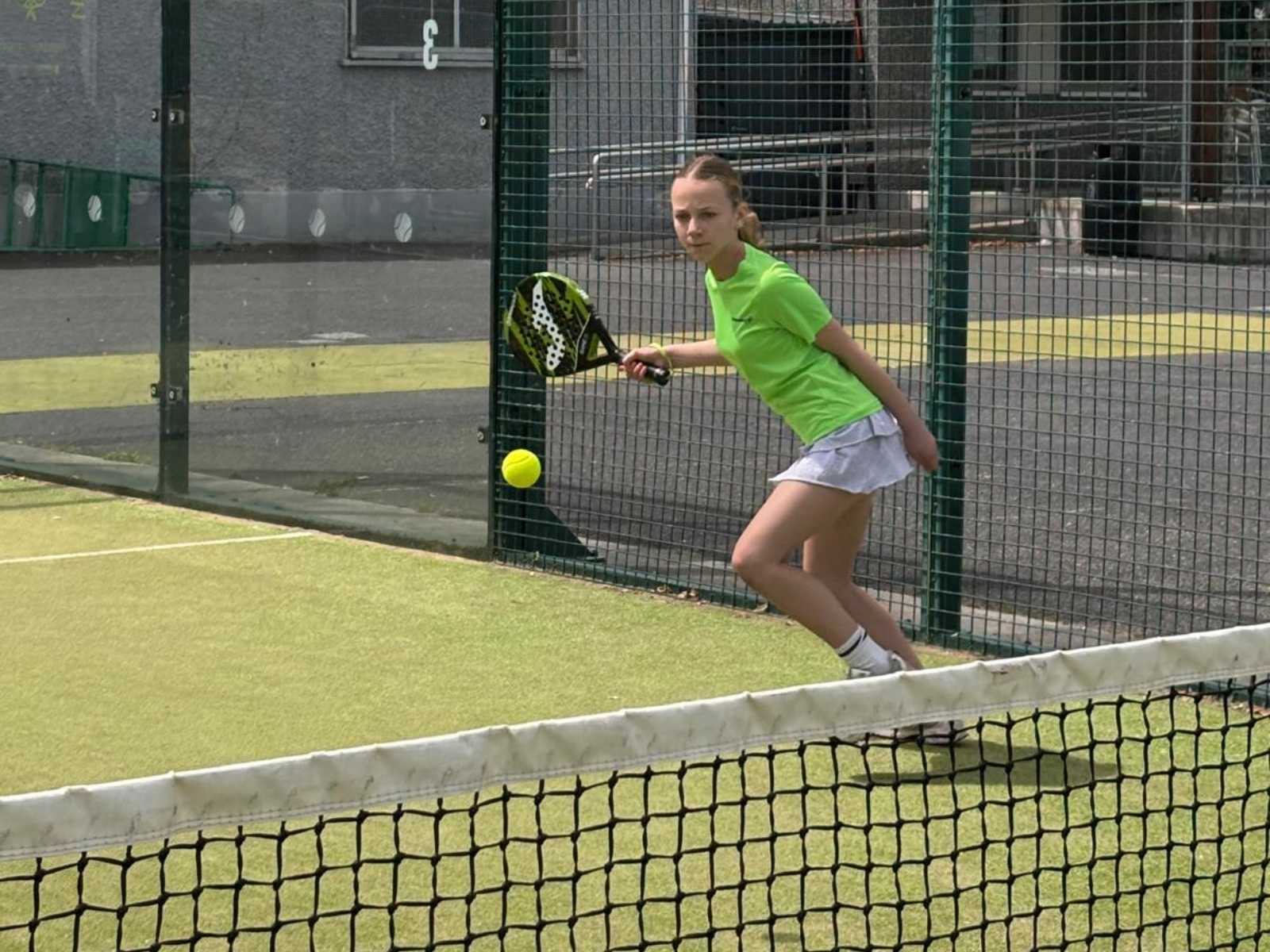 Junior padel players training on court